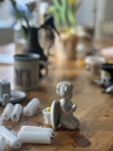 Small statue on desk. Sunlight though the window.